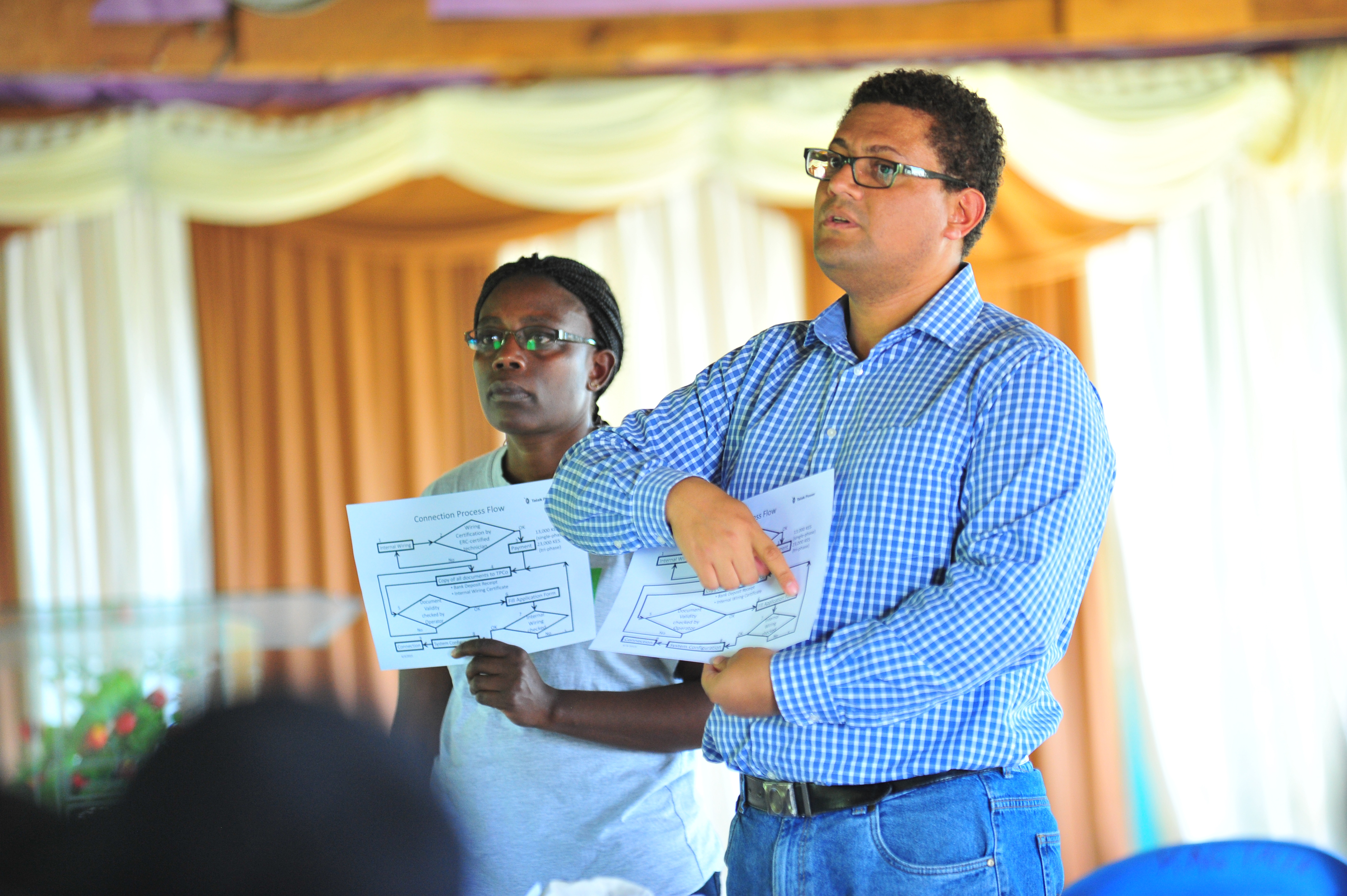 Pierre Telep GIZ programme advisor explains how solar power will be distributed to residents of Talek during a public baraza at AIC Talek town. Through Talek Power, GIZ and other partners have constructed a solar power grid which will connect residents of Talek town in Narok to power for domestic and industrial use.