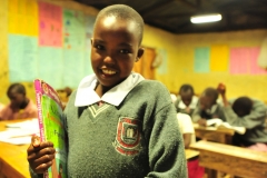 A pupil carries her books to class during night preps at Talek mixed day and boarding primary school. The school relies on its' solar panels for lighting especially after sunset because Talek town is not connected to the national power grid. Residents and business owners in Talek have had to rely on alternative power sources but this is set to change with the Talek Solar Powered Mini Grid. Through Talek Power, GIZ and other partners have constructed a solar power grid which will connect residents of Talek town in Narok to power for domestic and commercial use.